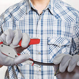 a person holding a pair of wire cutters