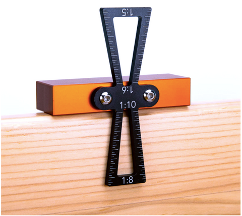 a black and orange square with white numbers on a wooden surface with text: '7 1:10 1:6 1:8'